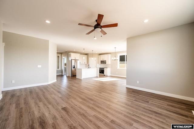 1275 Oxbow Dr, Sheridan, WY 82801 - unfurnished living room with baseboards, ceiling fan, and recessed lighting