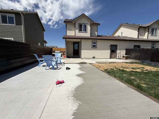 back of property with a patio and fence