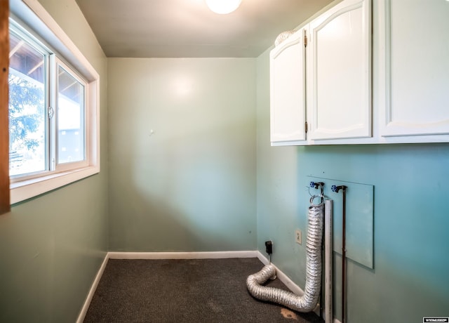 washroom with carpet, cabinet space, and baseboards