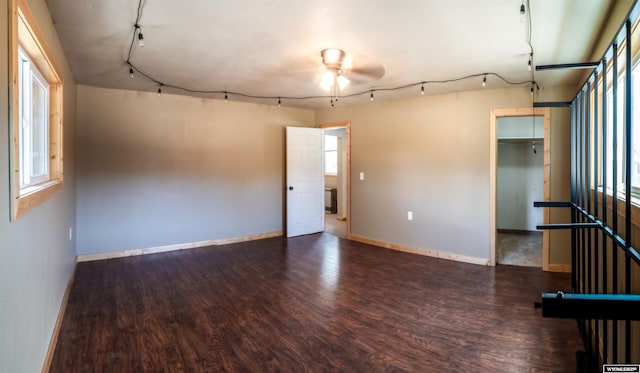 spare room with ceiling fan, wood finished floors, and baseboards