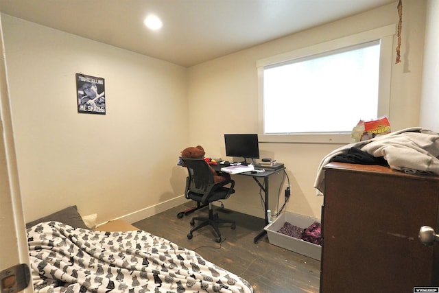 bedroom with baseboards and wood finished floors
