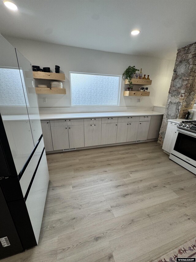 822 W St, Rock Springs, WY 82901 - kitchen with open shelves, range, light countertops, light wood-type flooring, and recessed lighting