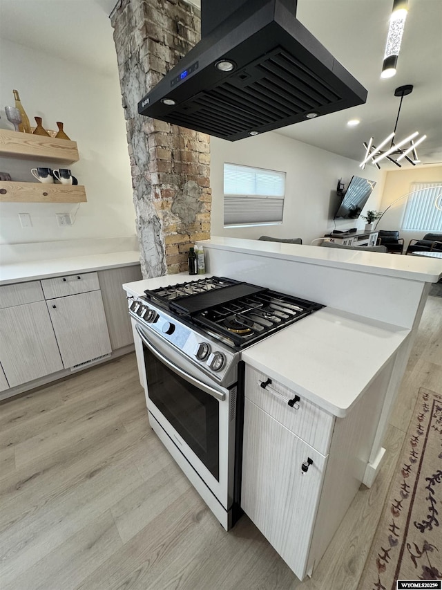822 W St, Rock Springs, WY 82901 - kitchen with stainless steel range with gas stovetop, extractor fan, light wood-style floors, light countertops, and open shelves