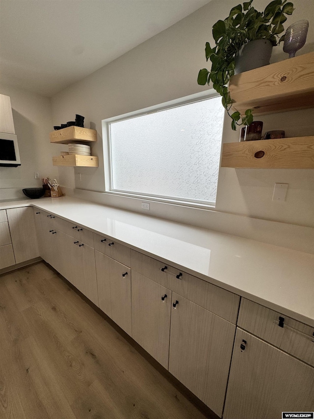 822 W St, Rock Springs, WY 82901 - kitchen with open shelves, light wood-style floors, and light countertops