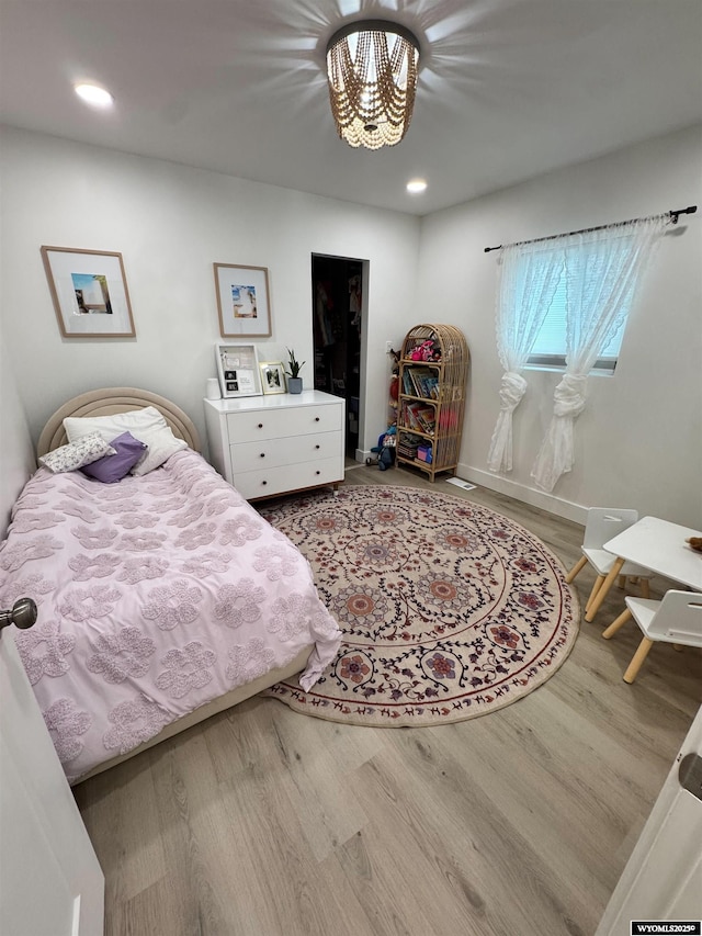 822 W St, Rock Springs, WY 82901 - bedroom with wood finished floors, a chandelier, recessed lighting, and baseboards