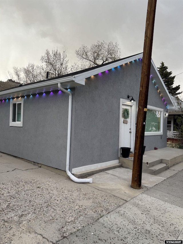 822 W St, Rock Springs, WY 82901 - view of property exterior with stucco siding and a patio area