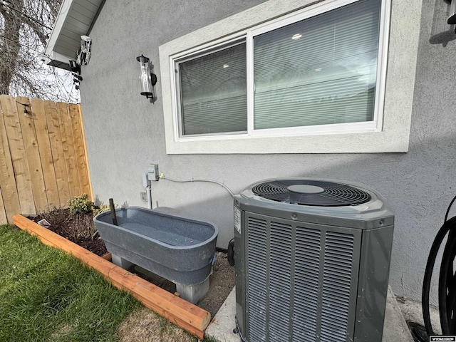 822 W St, Rock Springs, WY 82901 - exterior view of stucco siding, cooling unit, and fence