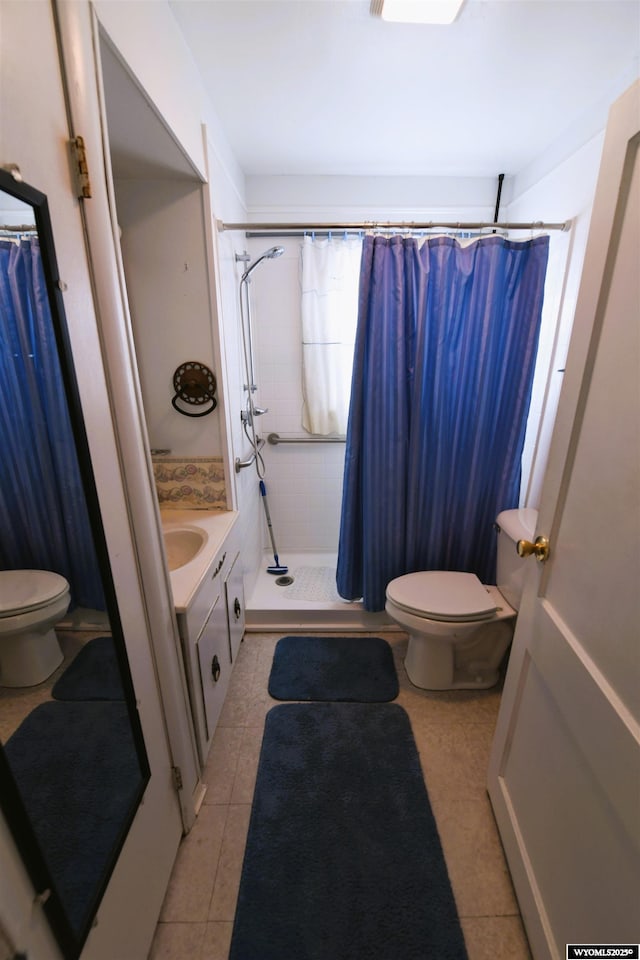 bathroom with vanity, curtained shower, toilet, and tile patterned floors