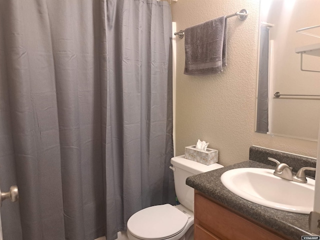 70B 27th St, Wheatland, WY 82201 - bathroom featuring vanity, toilet, a textured wall, and a shower with curtain