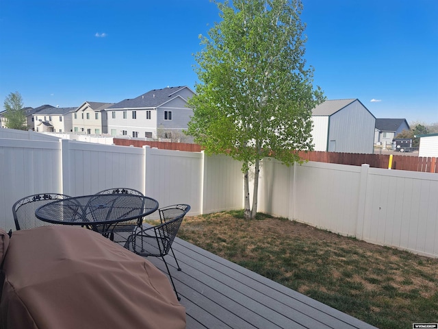 70B 27th St, Wheatland, WY 82201 - wooden deck with a fenced backyard, outdoor dining space, and a residential view