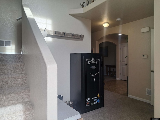 70B 27th St, Wheatland, WY 82201 - stairway featuring arched walkways, carpet flooring, and visible vents