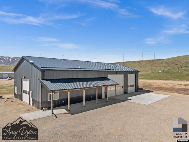 4297 Douglass, Casper, WY 82604 - rear view of property with a rural view, metal roof, a garage, and a mountain view