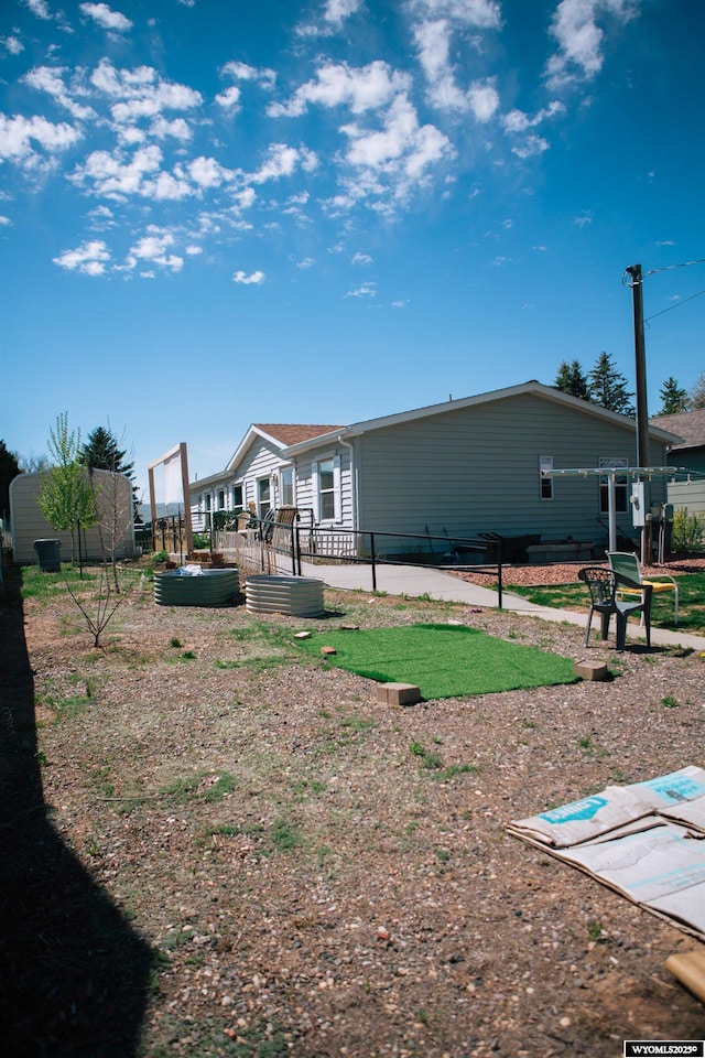 rear view of property featuring fence