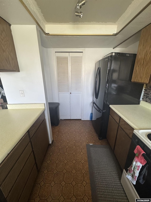 117 Sandstone Dr, Evanston, WY 82930 - kitchen featuring freestanding refrigerator, white range, and light countertops