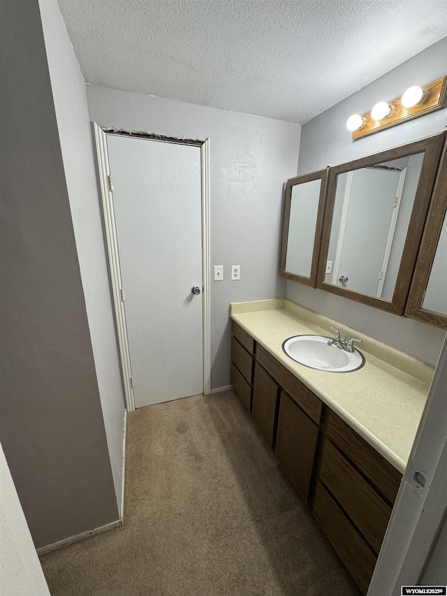 117 Sandstone Dr, Evanston, WY 82930 - bathroom featuring carpet, a textured ceiling, and vanity