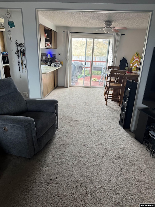 117 Sandstone Dr, Evanston, WY 82930 - living area featuring a ceiling fan, a textured ceiling, and light colored carpet