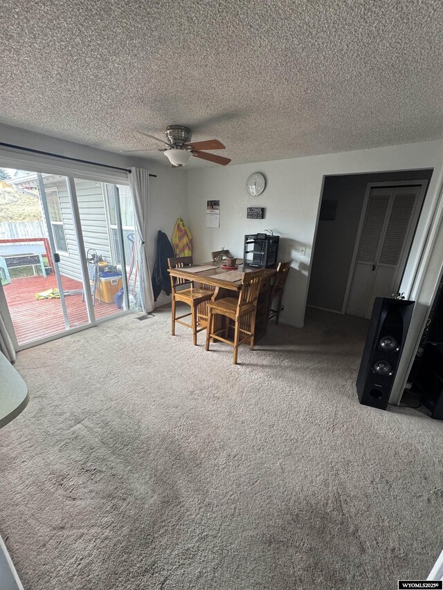 117 Sandstone Dr, Evanston, WY 82930 - carpeted dining room featuring visible vents, ceiling fan, and a textured ceiling
