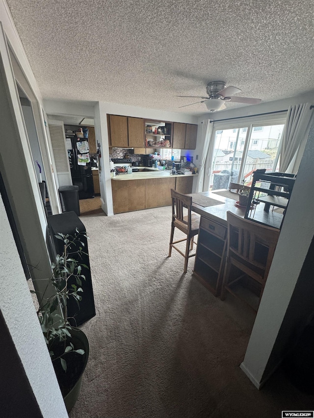 117 Sandstone Dr, Evanston, WY 82930 - carpeted dining space with a ceiling fan and a textured ceiling