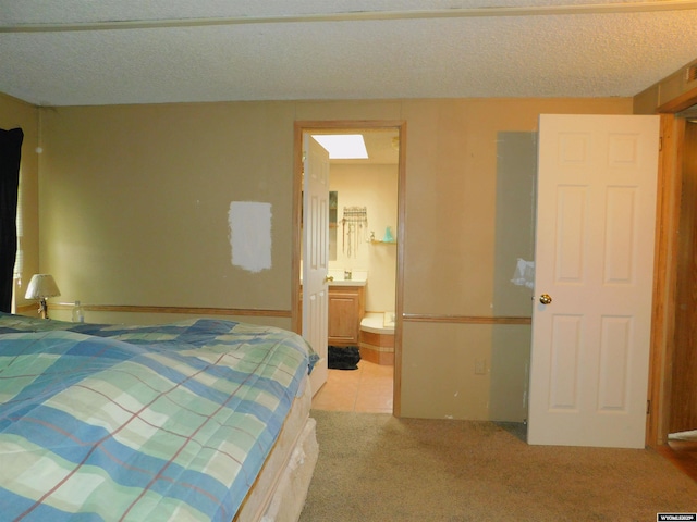 479 Hoskins Ln, Rock Springs, WY 82901 - carpeted bedroom featuring connected bathroom and a textured ceiling
