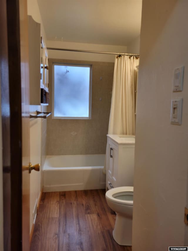 1001 Country Club Rd, Casper, WY 82609 - bathroom featuring toilet, wood finished floors, and shower / tub combo with curtain