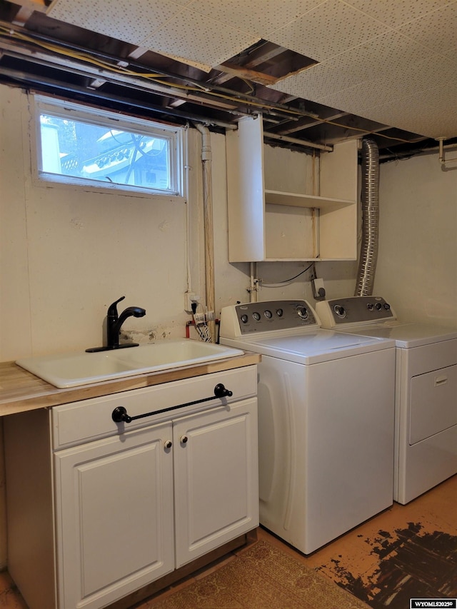 1001 Country Club Rd, Casper, WY 82609 - clothes washing area with washer and clothes dryer and cabinet space