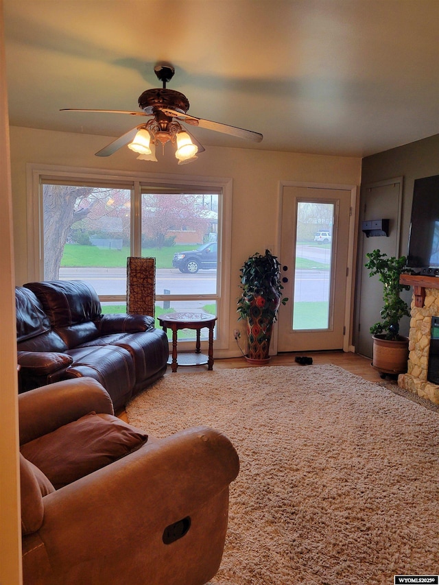 1001 Country Club Rd, Casper, WY 82609 - living area featuring a ceiling fan, healthy amount of natural light, wood finished floors, and a fireplace
