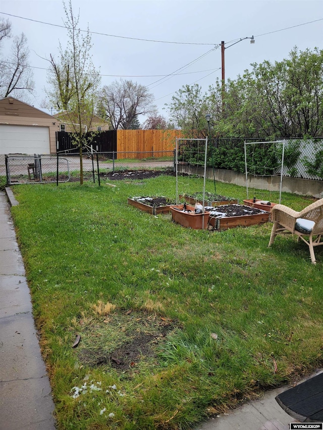 1001 Country Club Rd, Casper, WY 82609 - view of yard featuring a vegetable garden and a garage