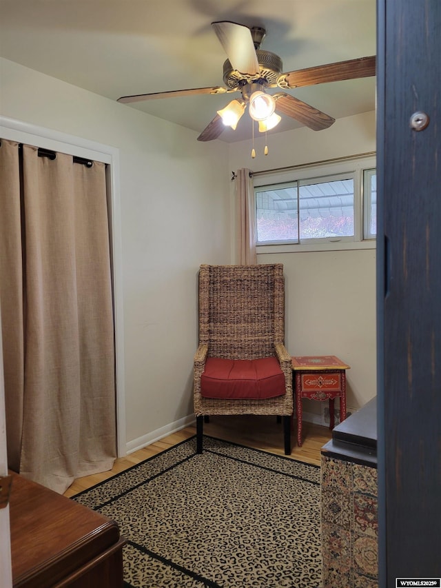 1001 Country Club Rd, Casper, WY 82609 - living area with wood finished floors, a ceiling fan, and baseboards