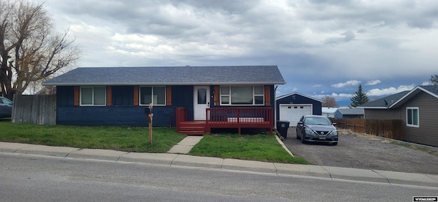 view of front of home with driveway, fence, a garage, a shingled roof, and a porch