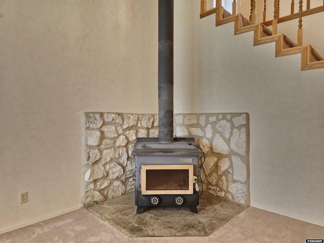 room details featuring a wood stove and carpet floors