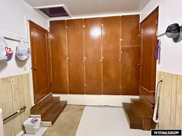 detailed view of wooden walls, finished concrete floors, and wainscoting