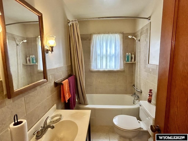 full bathroom with tile walls, shower / bath combo with shower curtain, toilet, vanity, and tile patterned floors