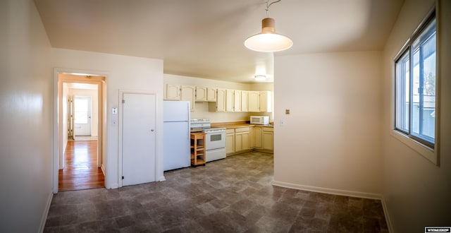 kitchen with white appliances, healthy amount of natural light, baseboards, and light countertops