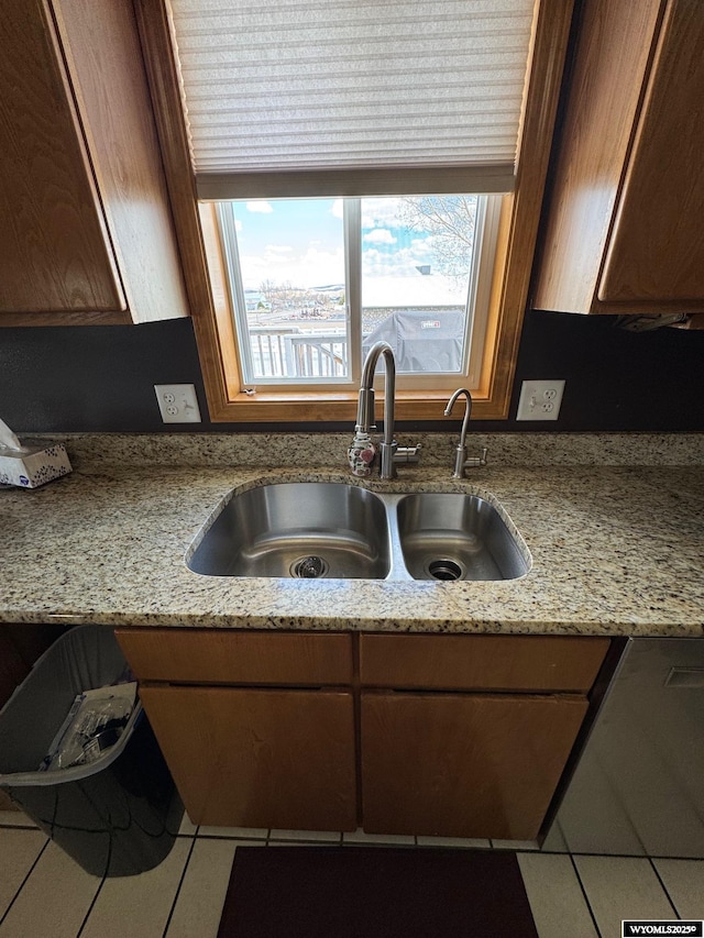 191 Lester Dr, Rock Springs, WY 82901 - kitchen featuring a sink, tile patterned floors, and light stone countertops