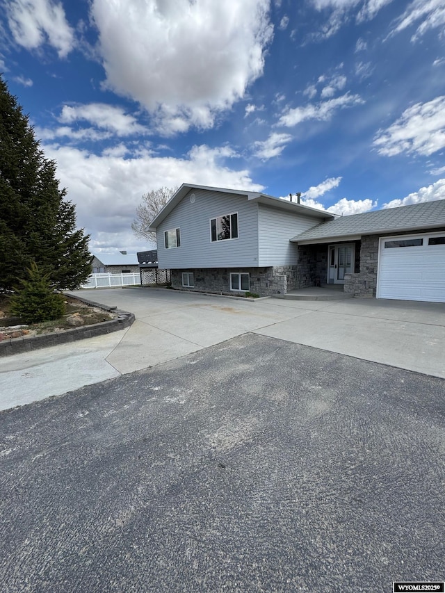 191 Lester Dr, Rock Springs, WY 82901 - tri-level home featuring concrete driveway and an attached garage
