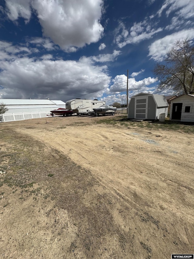 191 Lester Dr, Rock Springs, WY 82901 - view of yard featuring a shed, an outbuilding, and fence