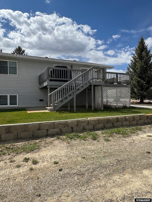 191 Lester Dr, Rock Springs, WY 82901 - rear view of property featuring a wooden deck, stairs, and a lawn