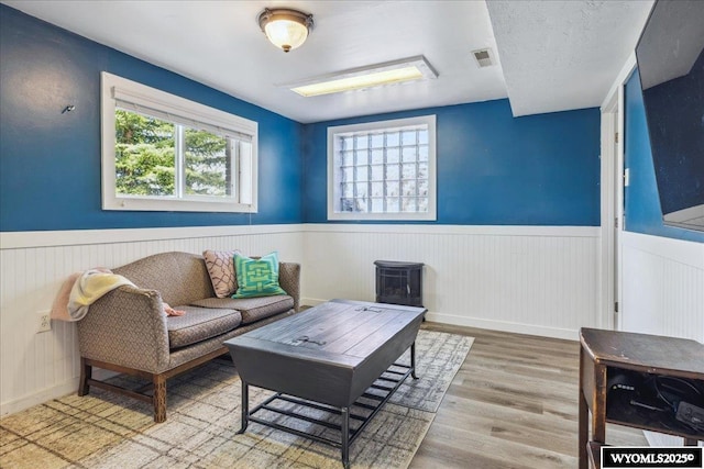 147 Apache Dr, Evanston, WY 82930 - living room featuring a wainscoted wall and wood finished floors