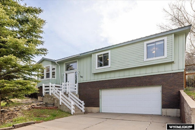 147 Apache Dr, Evanston, WY 82930 - bi-level home featuring brick siding, board and batten siding, a garage, and concrete driveway