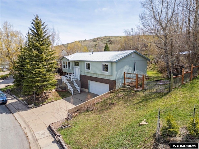 147 Apache Dr, Evanston, WY 82930 - ranch-style home with a garage, stairway, and driveway