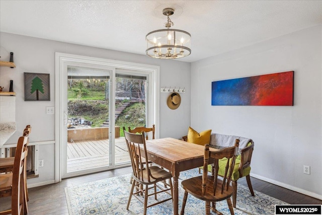 147 Apache Dr, Evanston, WY 82930 - dining space featuring a chandelier, wood finished floors, baseboards, and a textured ceiling