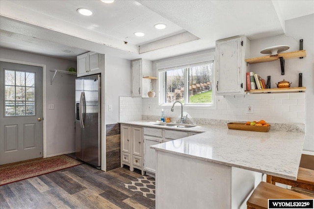 147 Apache Dr, Evanston, WY 82930 - kitchen featuring a sink, open shelves, stainless steel refrigerator with ice dispenser, a peninsula, and dark wood-style floors