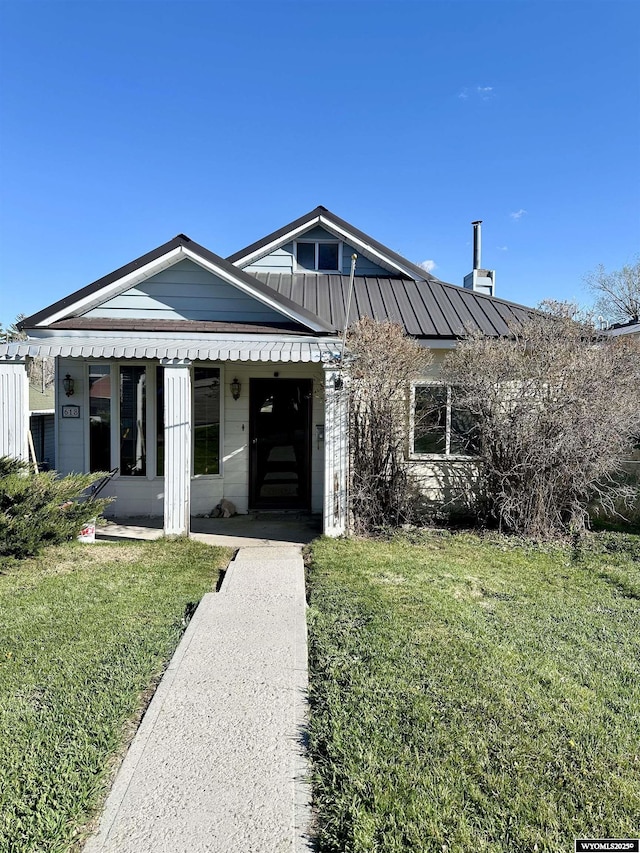 618 Emerald St, Kemmerer, WY 83101 - view of front of house with a front yard, a standing seam roof, and metal roof