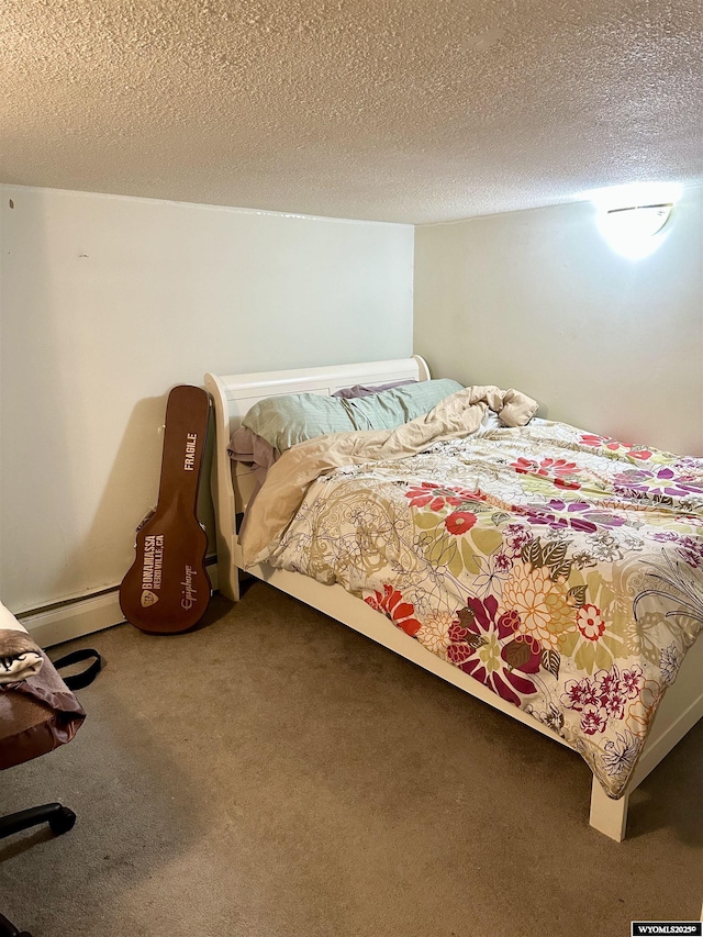bedroom featuring carpet floors, a baseboard heating unit, and a textured ceiling