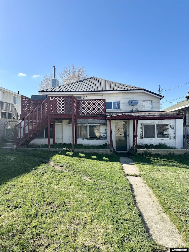 618 Emerald St, Kemmerer, WY 83101 - rear view of property with a lawn, a chimney, stairway, and metal roof