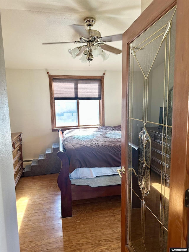 bedroom with wood finished floors and ceiling fan
