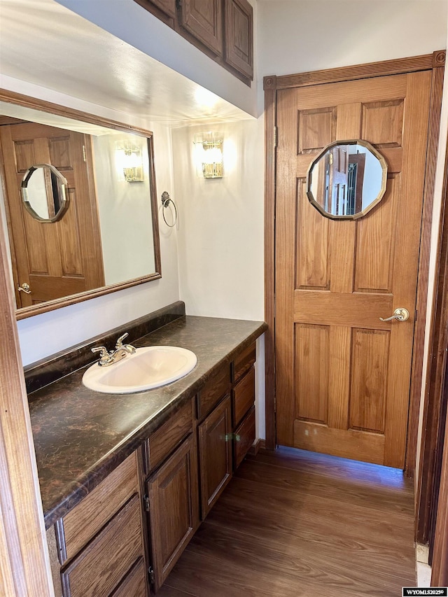 bathroom with wood finished floors and vanity