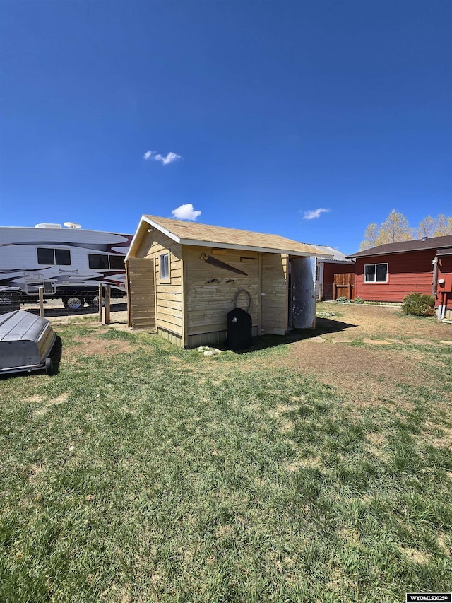 716 E 3rd St, Marbleton, WY 83113 - view of property exterior with an outdoor structure and a yard