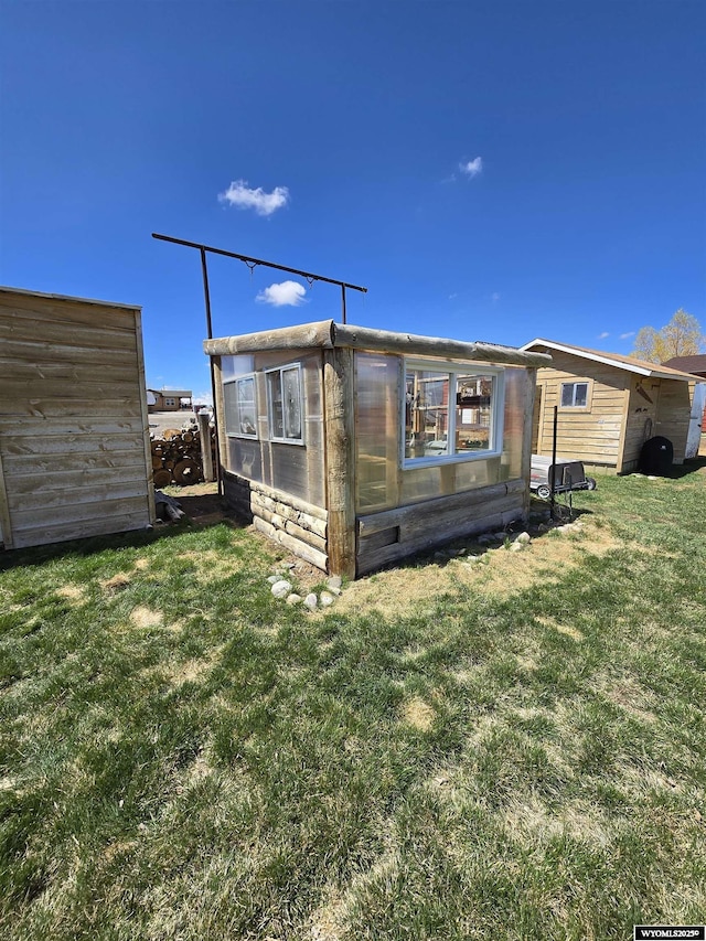 716 E 3rd St, Marbleton, WY 83113 - back of house with a yard and an outdoor structure
