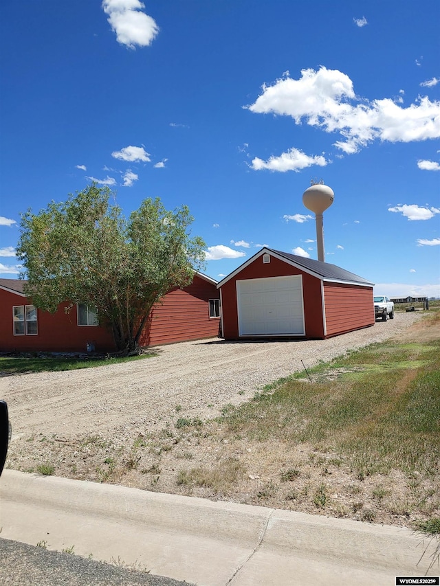 716 E 3rd St, Marbleton, WY 83113 - view of front of house featuring driveway and a garage